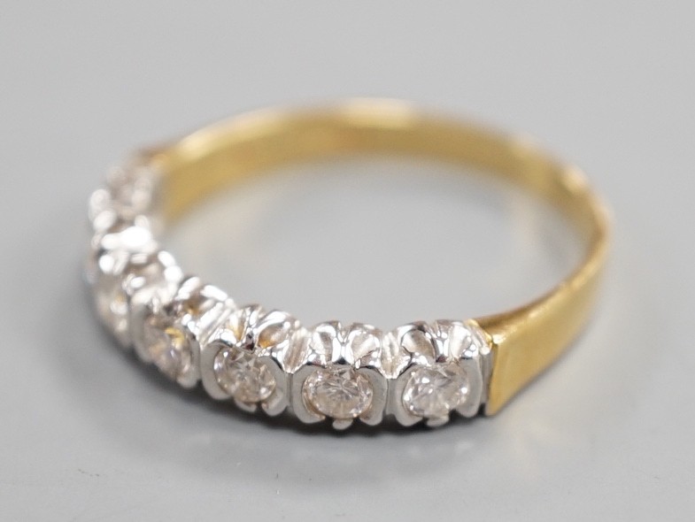 A modern 18ct gold and seven stone diamond set half hoop ring, size T, gross weight 3.9 grams.